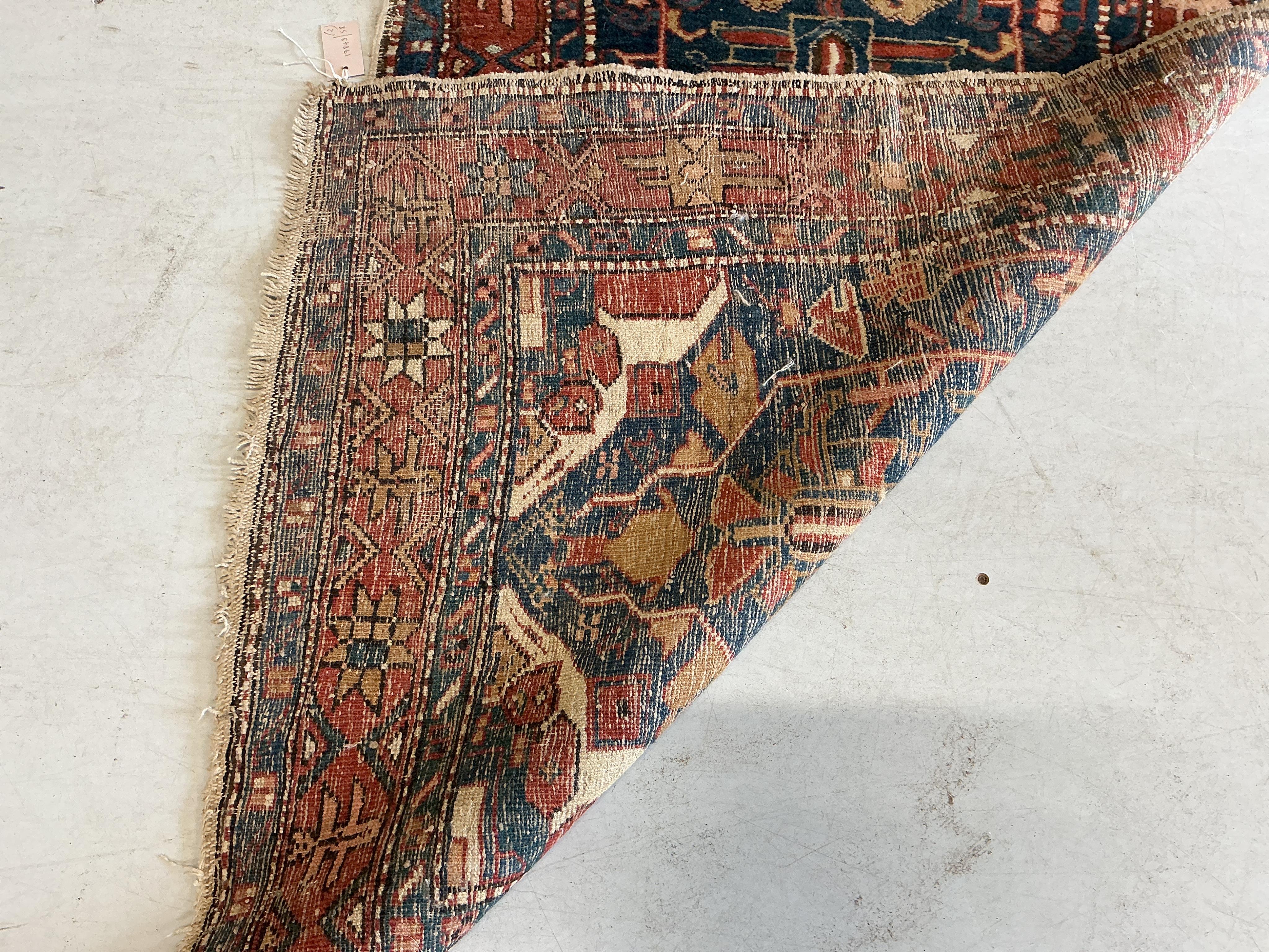An antique Caucasian blue ground runner and a Caucasian red ground rug (heavily worn), larger 336 x 87cm